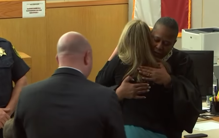 Judge Tammy Kemp hugs Amber Guyger after sentencing. 