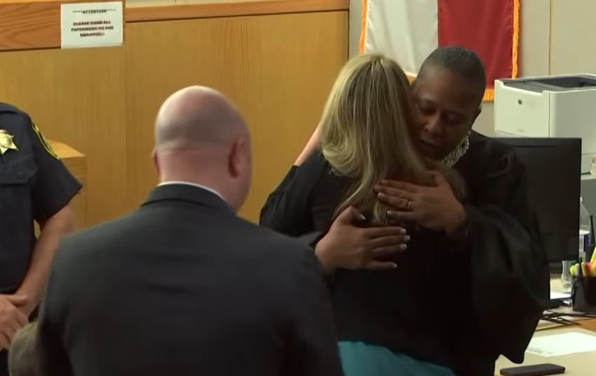 Judge Tammy Kemp hugs Amber Guyger after sentencing.