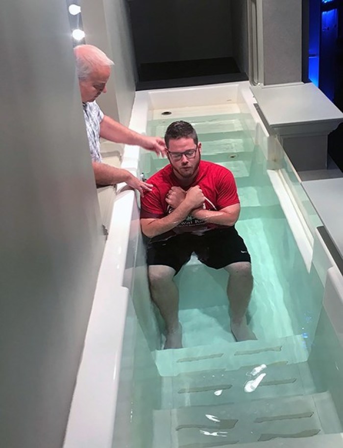 Mike Lefler, associate pastor of ministries at Central Baptist Church in Conway, Ark., prepares to baptize Brenton Winn during a Wednesday night service in September. 