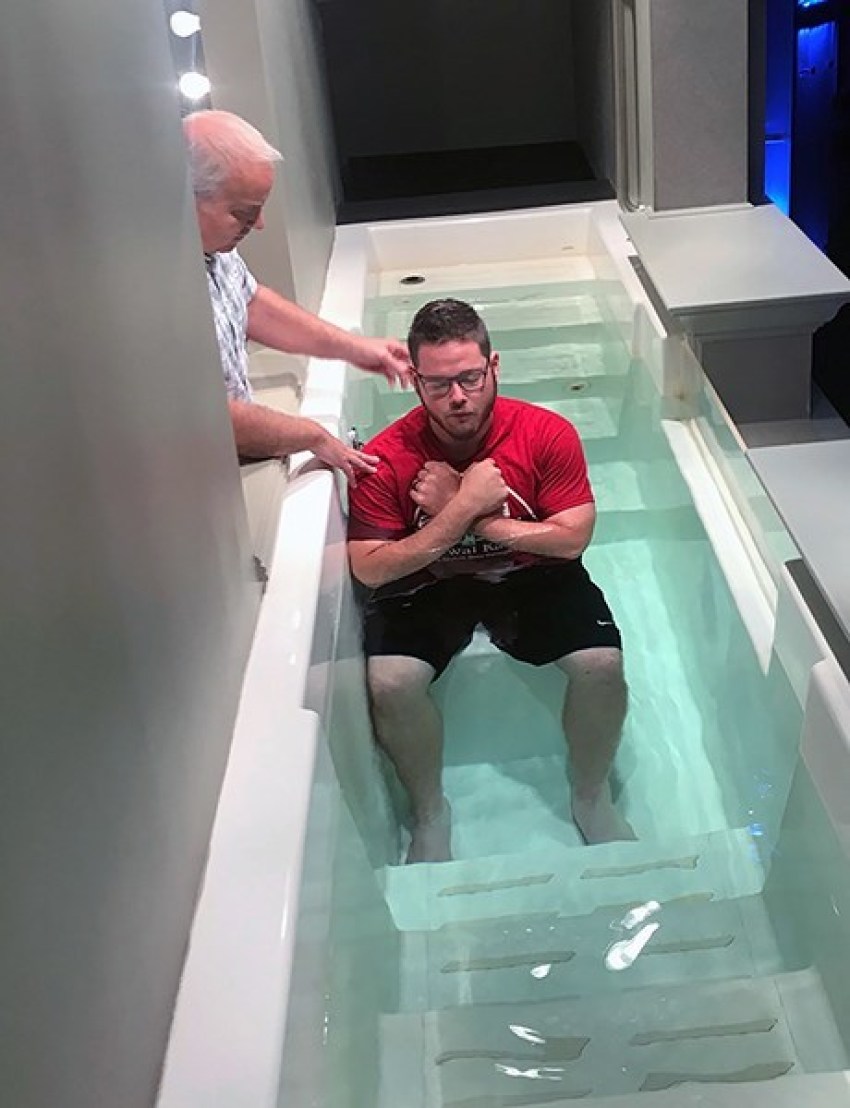 Mike Lefler, associate pastor of ministries at Central Baptist Church in Conway, Ark., prepares to baptize Brenton Winn during a Wednesday night service in September.