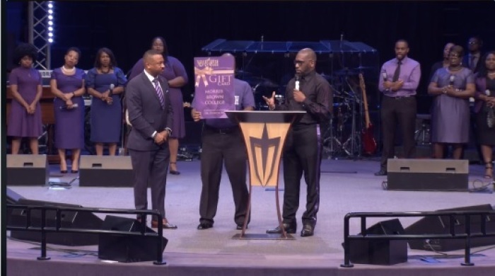 Rev. Jamal Bryant (R) speaks during a Sunday service at New Birth Missionary Baptist Church in Georgia on Oct. 13, 2019. Joining him on stage is Morris Brown College President Kevin James (L).