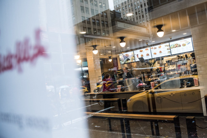  A cab is reflected in the window of Chick-fil-A on Oct. 2, 2015, in New York City.
