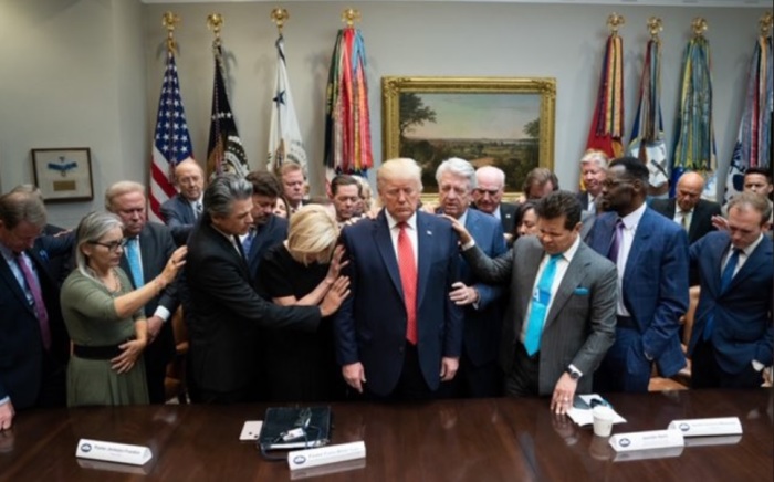 Several faith leaders lay hands on President Donald Trump at an informal meeting held at the Roosevelt Room in the White House in Washington, D.C., Oct. 29, 2019. 