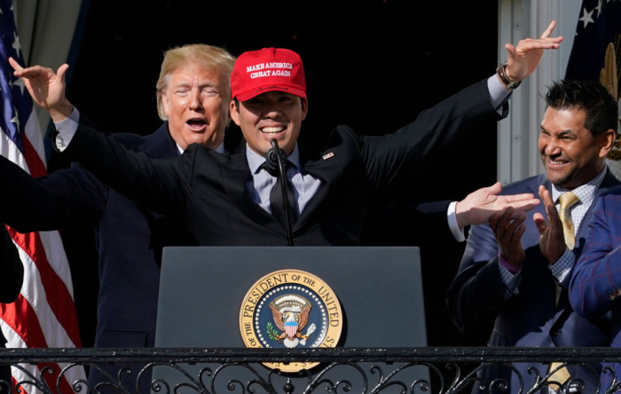 Catcher Kurt Suzuki wears a 'Make America Great Again' hat as he is embraced by U.S. President Donald Trump as he welcomes the 2019 World Series Champions, the Washington Nationals, to the White House November 4, 2019 in Washington, D.C. The Nationals are Washington’s first Major League Baseball team to win the World Series since 1924. Also pictured is Nationals Manager Davey Martinez (R). 