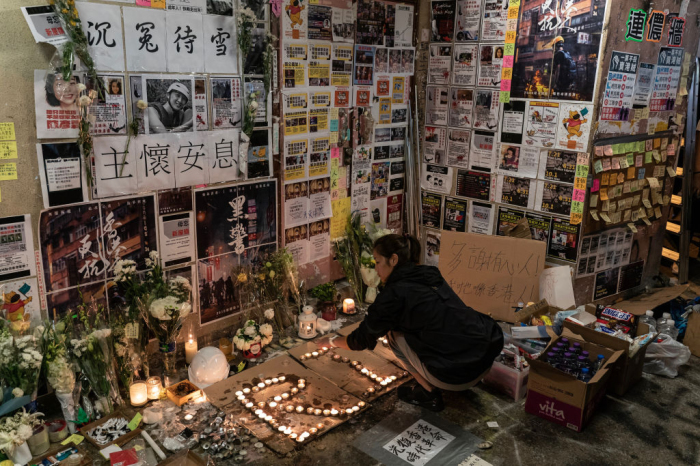 A woman pays her respect to 22-year-old student Alex Chow who fell during a recent protest on November 10, 2019, in Hong Kong, China. 