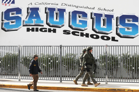 Members of law enforcement walk at Saugus High School after a shooting at the school left two students dead and three wounded on November 14, 2019, in Santa Clarita, California.