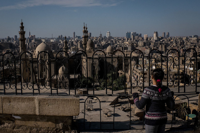 A young girl looks out over the Cairo skyline on December 16, 2016, in Cairo, Egypt.