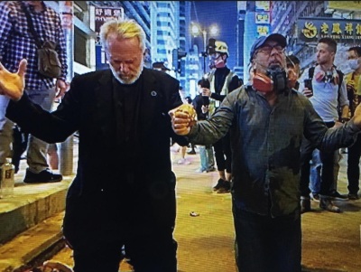 Rev. Bill Devlin (L) and Rev. Patrick Mahoney (R) pray in Hong Kong in November 2019. 