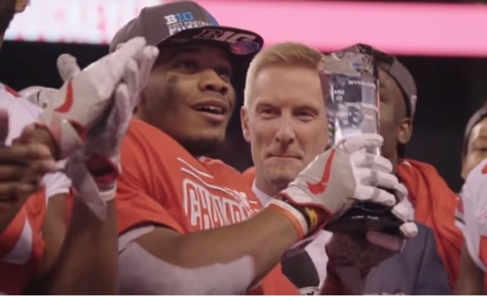 Ohio State running back J.K. Dobbins holds up the Big Ten Championship MVP trophy in 2017. 