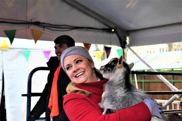 Actress Melissa Joan Hart lifts a goat kid inside World Vision’s interactive pop-up shop in Bryant Park's Winter Village in Midtown, Manhattan on Tuesday December 3, 2019.