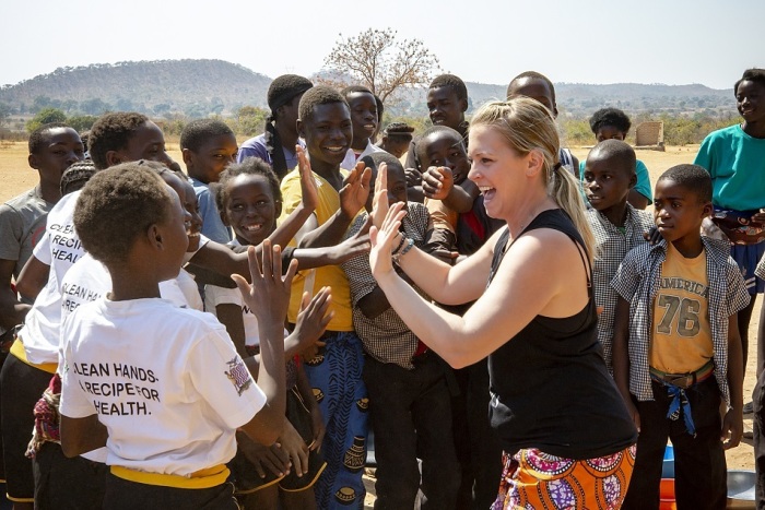 Actress Melissa Joan Hart meets with villagers in rural Zambia in August 2019.