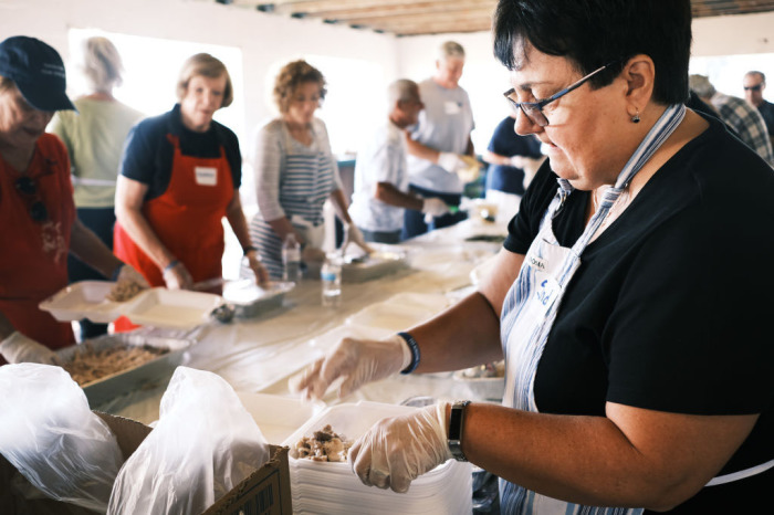 Volunteers prepare food at the annual Thanksgiving in the Park gathering where residents of the farm worker community of Immokalee are provided with a free Thanksgiving meal on November 28, 2019, in Immokalee, Florida. Now in its 38th year, the event is sponsored by area faith based organizations and serves approximately 1,500 people on Thanksgiving Day. The Immokalee community is made up mainly of seasonal farm workers.