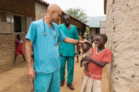 Dr. Tom Catena with children in the Nuba Mountains of Sudan.
