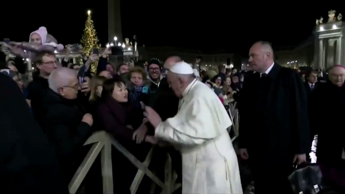 Pope Francis slaps an admirer who grabbed him aggressively as he greeted pilgrims around the Vatican’s giant Nativity scene after a New Year’s Eve liturgy. 