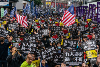 Pro-democracy supporters hold placards and shout slogan as they take part in a march during a rally on New Years Day on January 1, 2020, in Hong Kong, China. 