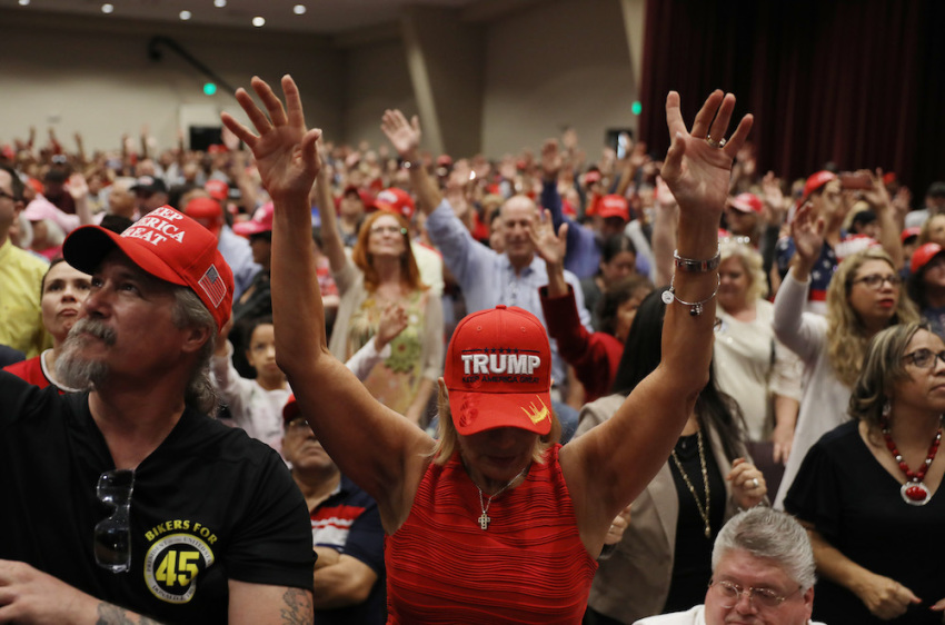 Fran Flynn (C) prays during the 'Evangelicals for Trump' campaign event held at the King Jesus International Ministry as they await the arrival of President Donald Trump on January 3, 2020, in Miami, Florida.