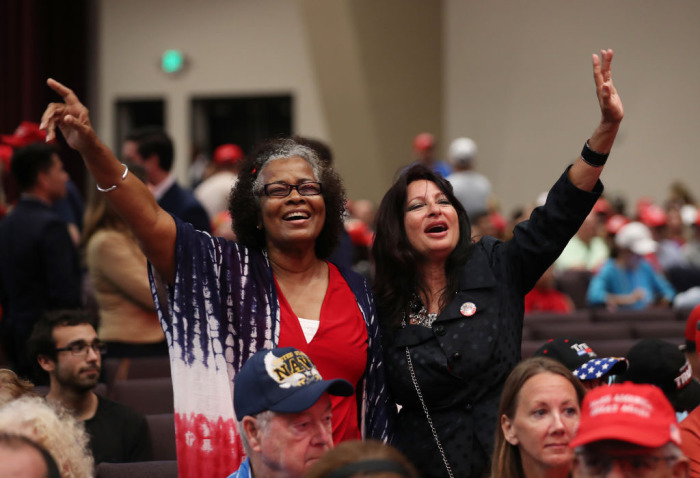 Pamela Williams and the Rev. Cindy Falco (L-R) pray together during the 'Evangelicals for Trump' campaign event held at the King Jesus International Ministry as they await the arrival of President Donald Trump on January 3, 2020, in Miami, Florida.