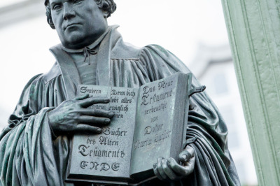 A statue of 16th-century theologian Martin Luther holds a Bible in the hand on the marketplace during the celebrations to commemorate the 500th anniversary of Luther's nailing of his 95 theses on the doors of the nearby Schlosskirche church on October 31, 2017, in Wittenberg, Germany. 