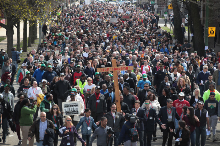 Marchers, led by Cardinal Blase Cupich, walk through the Englewood neighborhood calling for an end to the violence that has plagued the city on April 14, 2017 in Chicago, Illinois. The marchers stopped several times to reflect on the Stations of the Cross and to read out the names of Chicago homicide victims. With 14 homicides so far in 2017, Englewood was one of the most violent neighborhoods in the city at the time. 