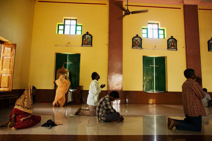Christians pray as others take confession during Good Friday prayer services on April 10, 2009, in the village of Raikia, south of Bhubaneswar, India. 