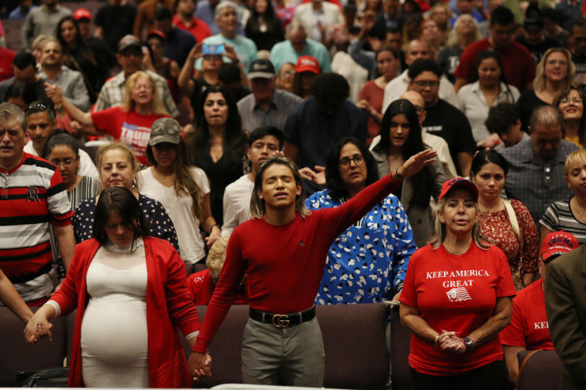 People pray together during the 'Evangelicals for Trump' campaign event held at the King Jesus International Ministry as they await the arrival of President Donald Trump on January 03, 2020 in Miami, Florida.