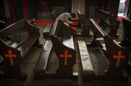 A Chinese Catholic woman prays at the government-sanctioned Xishiku Catholic Church on August 14, 2014, in Beijing, China.