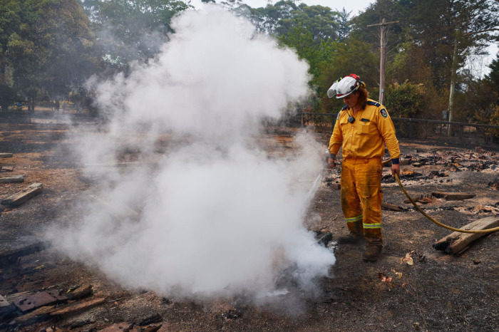 An RFS Crew attempts to put out a smoldering pile of railway sleepers. The sleepers measured over 600 degrees on a thermal temperature gauge 2 days after the fire front had passed through on January 06, 2020, in Wingello, Australia. Cooler conditions and light rain has provided some relief for firefighters in NSW who continue to battle bushfires across the state. Army Reserve forces and other specialist capabilities have been called in to help with firefighting efforts across Australia, along with extra Defence ships and helicopters. 