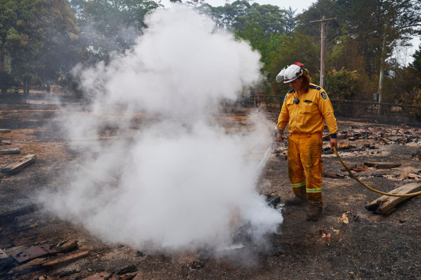 An RFS Crew attempts to put out a smoldering pile of railway sleepers. The sleepers measured over 600 degrees on a thermal temperature gauge 2 days after the fire front had passed through on January 06, 2020, in Wingello, Australia. Cooler conditions and light rain has provided some relief for firefighters in NSW who continue to battle bushfires across the state. Army Reserve forces and other specialist capabilities have been called in to help with firefighting efforts across Australia, along with extra Defence ships and helicopters.