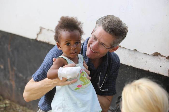 Dr. Paul Osteen poses with young patient in Kenya.