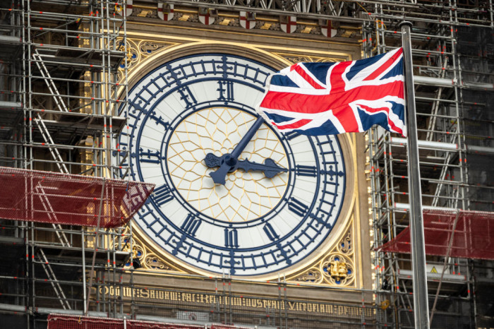 The Union flag flies in front of the Clock face on the Queen Elizabeth Tower, commonly referred to as Big Ben on April 2, 2019, in London, England. 