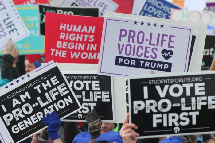 Demonstrators hold up signs at the 2020 March for Life in Washington, D.C. on Jan. 24, 2020. 