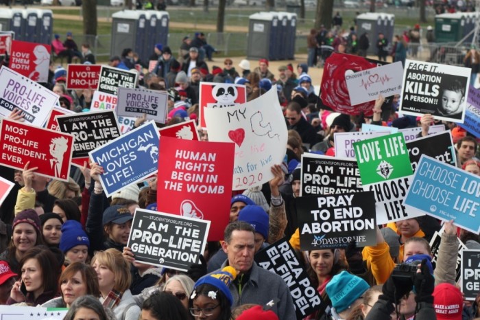 Pro-life demonstrators hold up signs during the 2020 March for Life in Washington, D.C. on Jan. 24, 2020.