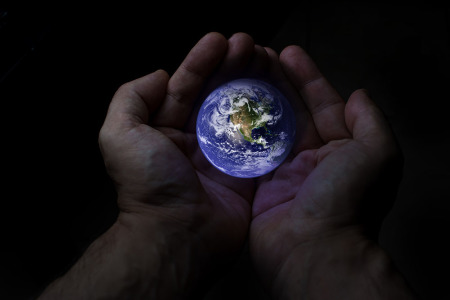 Hands holding the Earth.