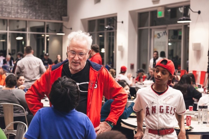 Los Angeles Angels Manager Joe Maddon talks with kids at a 'Thanksmas' event put on by his Respect 90 Foundation at the Orange County Rescue Mission's Village of Hope in Tustin, California, on Jan. 28, 2020.