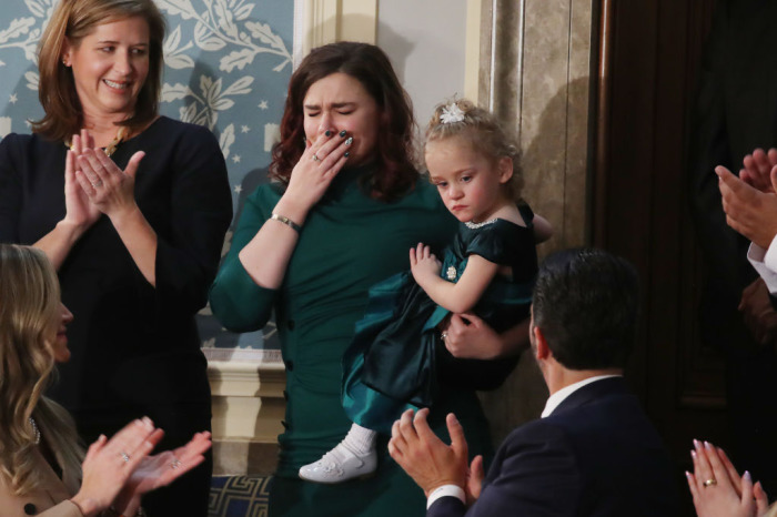 Guests of President Trump Robin (2nd L) and her daughter, Ellie Schneider, attend the State of the Union address in the chamber of the U.S. House of Representatives on February 04, 2020, in Washington, D.C. 