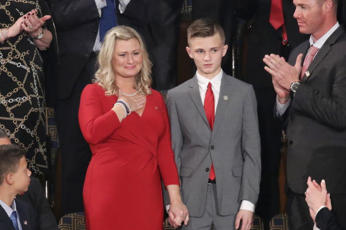 Kelli Hake, the widow of a U.S. soldier killed in Iraq in 2008, attends the State of the Union address with her son, Gage Hake, in the chamber of the U.S. House of Representatives on February 04, 2020, in Washington, D.C. 