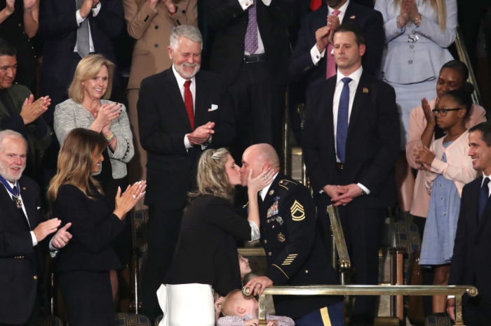 Sgt. 1st Class Townsend Williams kisses his wife Amy after surprising his family by returning early from deployment in Afghanistan during the State of the Union address in the chamber of the U.S. House of Representatives on February 04, 2020, in Washington, D.C. 