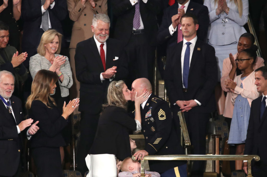 Sgt. 1st Class Townsend Williams kisses his wife Amy after surprising his family by returning early from deployment in Afghanistan during the State of the Union address in the chamber of the U.S. House of Representatives on February 04, 2020, in Washington, D.C.
