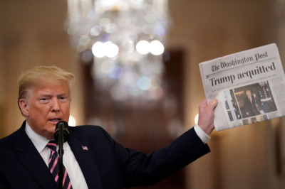 President Donald Trump holds a copy of The Washington Post as he speaks in the East Room of the White House one day after the U.S. Senate acquitted him on two articles of impeachment brought by Democrats in the House without bipartisan support, on February 6, 2020, in Washington, D.C. 
