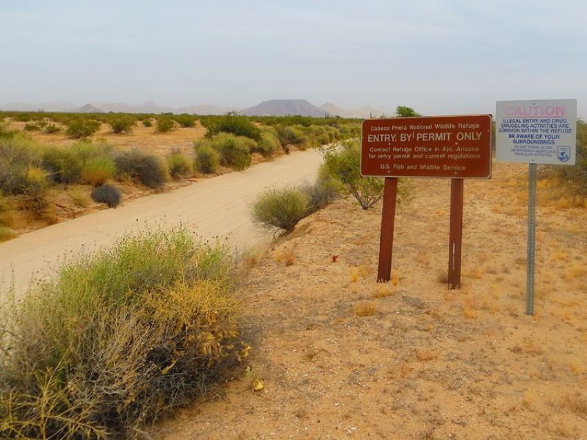 A sign is posted along the El Camino Del Diablo roadside at the western entrance to Cabeza Prieta National Wildlife Refuge in Arizona.