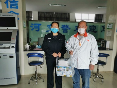A World Vision worker holds up boxes of facemasks during the 2019-2020 coronavirus outbreak in China. 