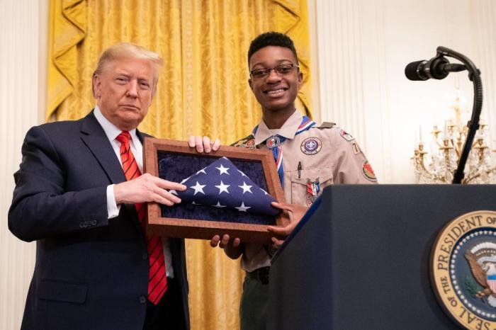President Donald Trump presents an award to Alphonso Hill Jr., 15, during a celebration of Black History Month at the White House on Thursday February 27, 2020. Hill is the first African American Eagle Scout in Swansboro, N.C. 