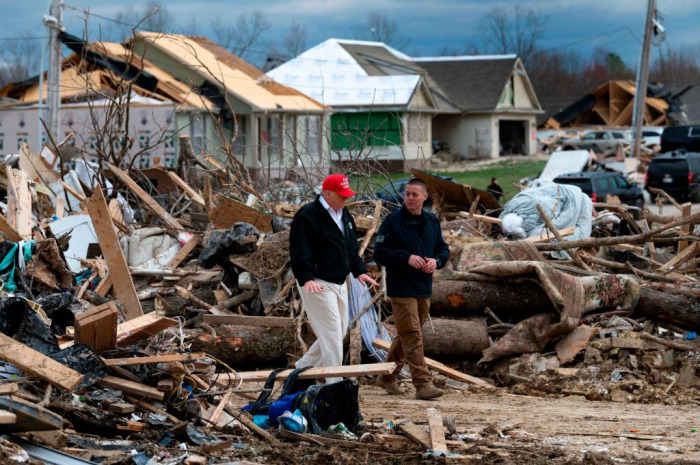US President Donald Trump tours tornado damage with Putnam County Rescue Squad member Mike Herrick (R) in Cookeville, Tennessee, on March 6, 2020. - At least 24 are dead in the wake of March 3 2020, terrible Tennessee tornadoes. They carved a long scar across Middle Tennessee in the dead of night, racking up a large death toll in the process. While downtown Nashville was hit hard, the town of Cookeville about 80 miles east of the state capital suffered the worst of the devastation. 