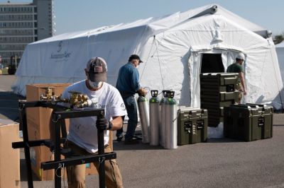 Workers set up the Samaritan's Purse emergency field hospital outside the Cremona Hospital in Cremona, Italy in March 2020. 