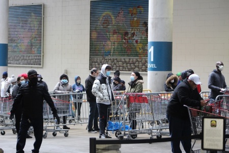 Customers wait for a Costco warehouse in Manhattan, New York, to open on March 29, 2020.