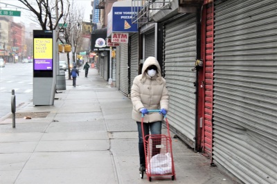 A woman walks in East Harlem, New York, during the coronavirus outbreak on March, 29, 2020.