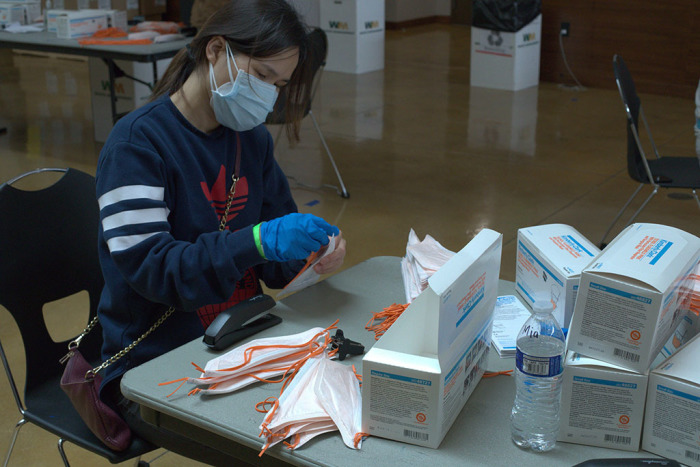 Volunteers assemble masks for medical staff at The Rock Church in California, April 6, 2020. 