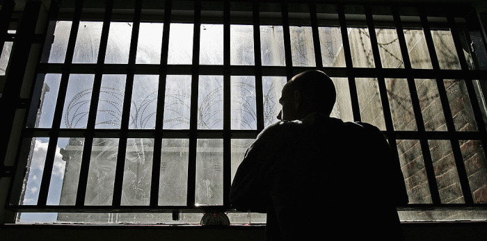 A 19 year old inmate looks out of the window of the Young Offenders Institution attached to Norwich Prison on August 25, 2005 in Norwich, England. 