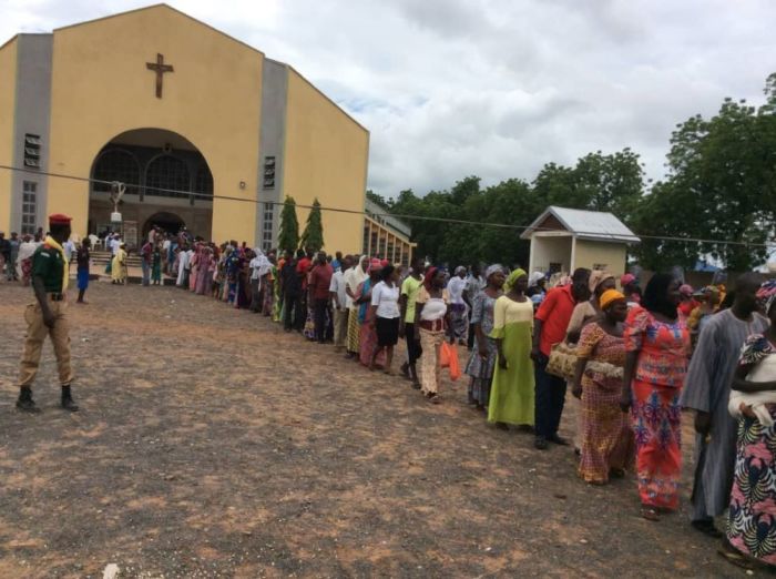 Internally displaced persons line up outside of St. Theresa's Cathedral in Yola, Nigeria. 