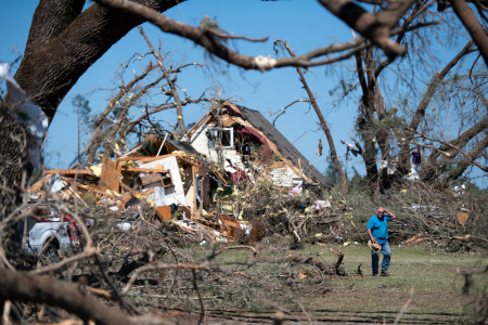 A man walks in front of a home destroyed by a tornado on April 13, 2020, near Nixville, South Carolina. A string of storms across the southern United States that began Easter Sunday and continued into Monday produced multiple tornados resulting in more than 30 deaths and dozens more injuries.
